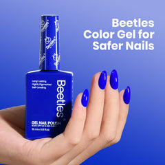 Hand with Beetles royal blue manicure showing long-lasting glossy finish and wearable style