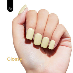 Beetles manicured hand wearing Lemon Cheese pastel yellow for bright, long-lasting nails