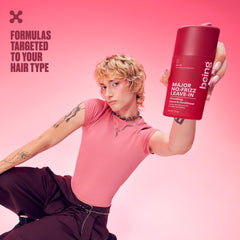 BEING INC bottle held in hand to show 227mL size and travel-friendly scale