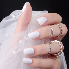 Bellelfin nails next to coin for scale showing short, wearable length