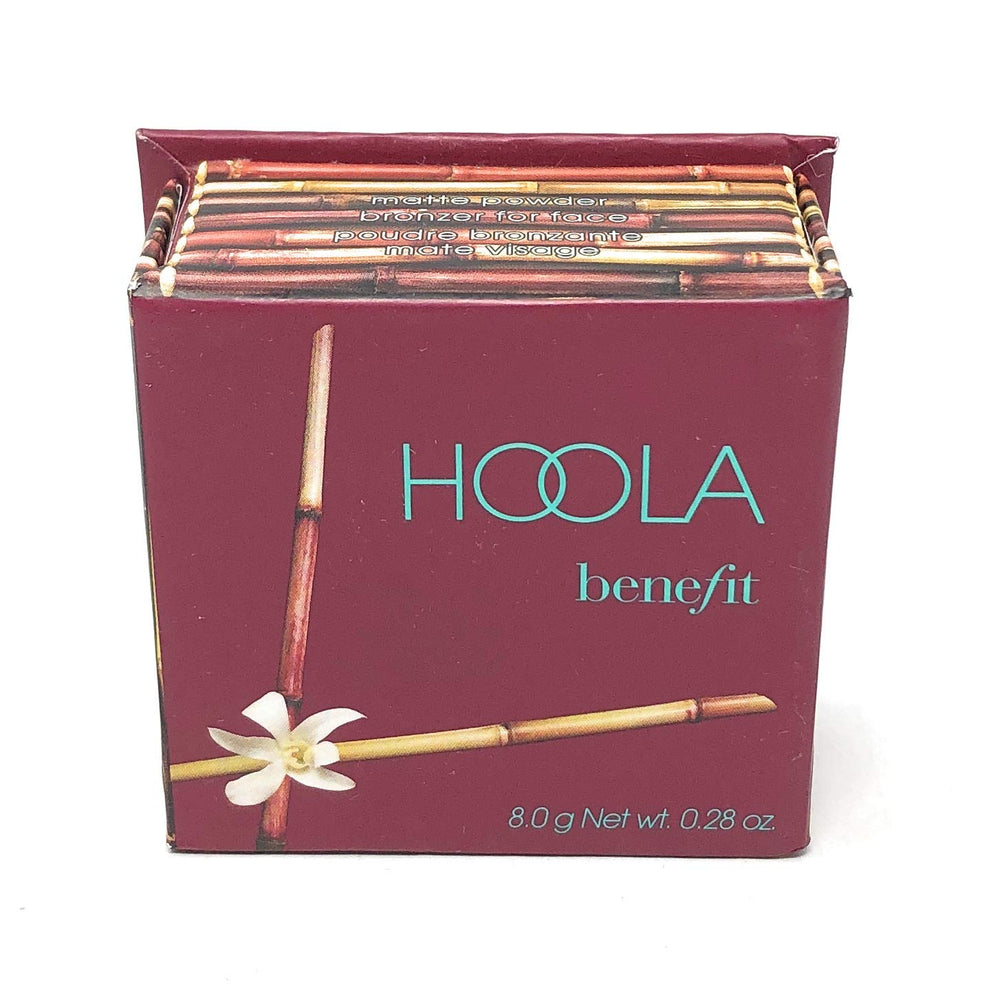 Benefit Hoola with brush in hand demonstrating easy application and quick touchup benefit