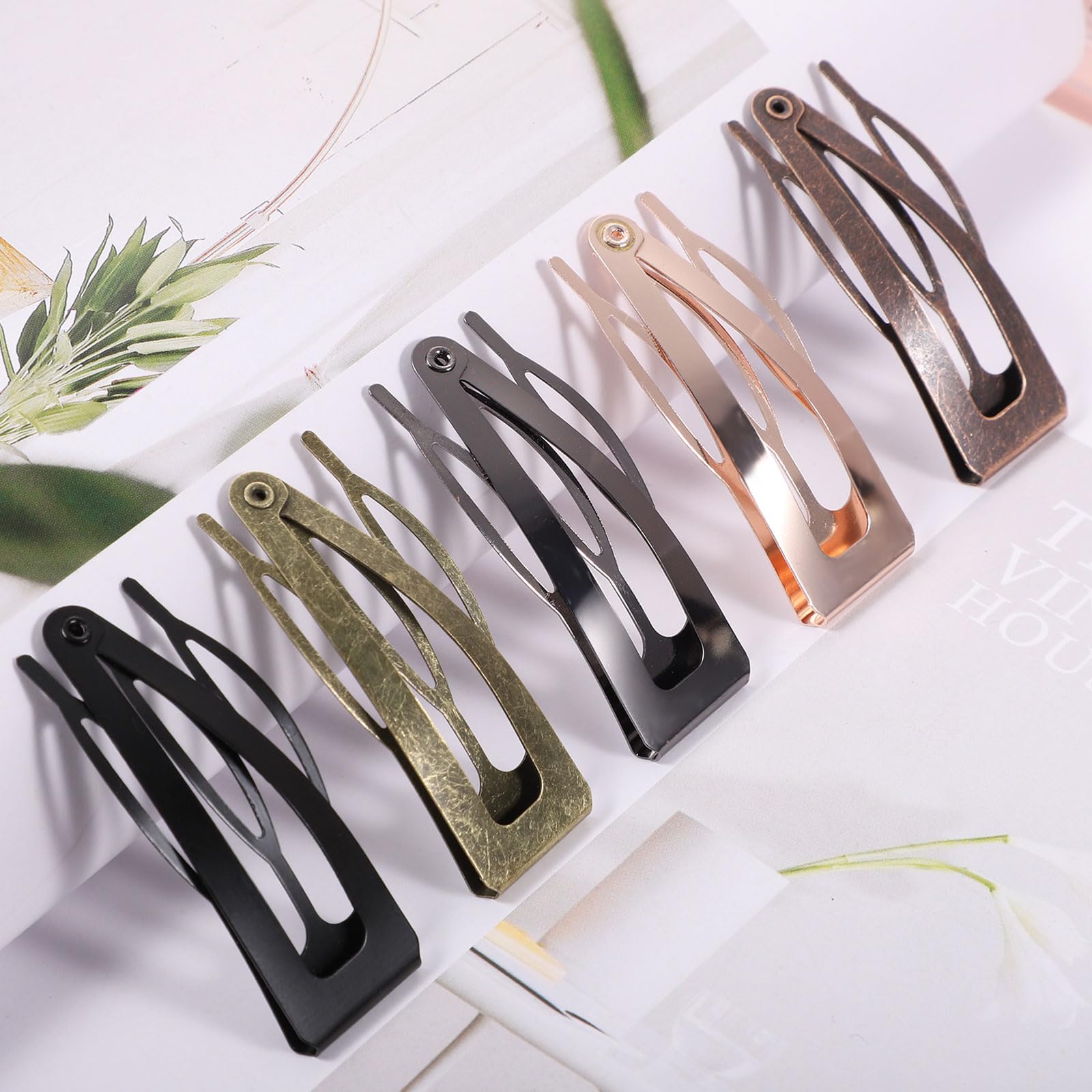 BESARME clips in hand showing 2-inch size and portability