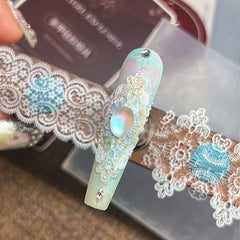 BHCCXZ applied lace piece on a model nail showing polished Y2K look