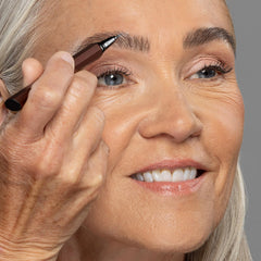 billion dollar brows pen beside travel pouch ready for commute and trips, on-the-go convenience