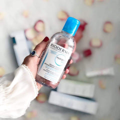Bioderma bottle in hand scales size and shows value of large 33.4 fl oz