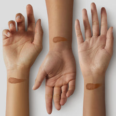 Black Radiance swatch on deep skin arm showing true Cappuccino payoff and color match benefit