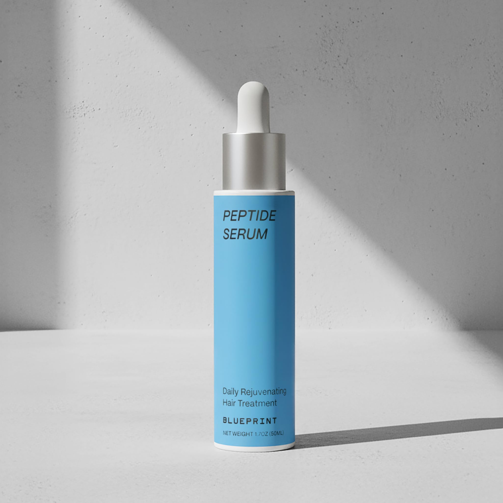 Blueprint Bryan Johnson precision dropper applying serum directly to scalp for targeted delivery