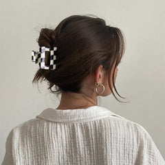 Bmobuo semicircle clip in a half-up hairstyle providing grip and retro flair