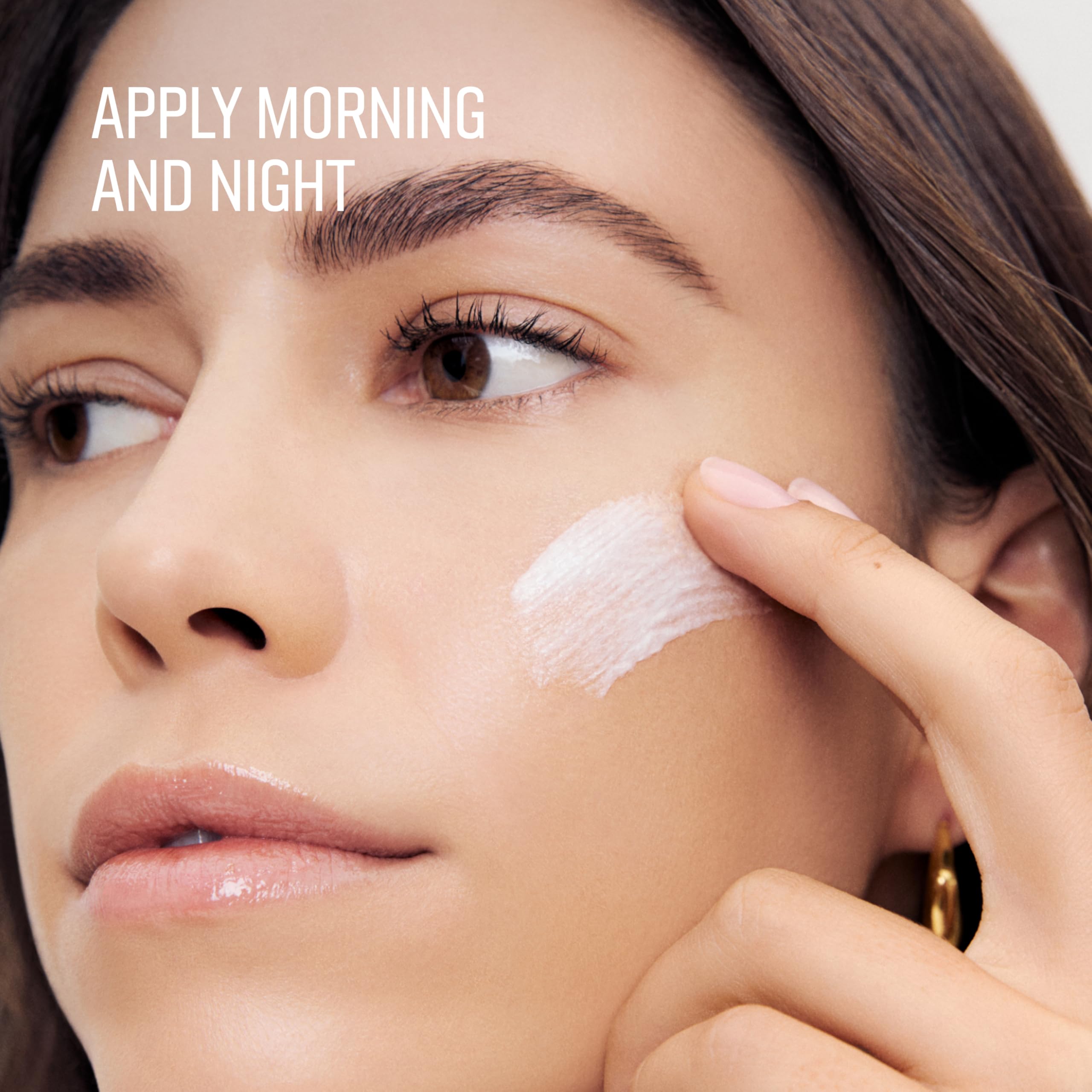 Bobbi Brown cream on fingers demonstrating lightweight spreadability and absorption