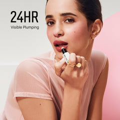 Bobbi Brown swiped on lips showing sheer Bare Pink tint and natural plumping effect