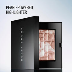 Bobbi Brown applying highlighter to cheekbone to create natural lift and illumination