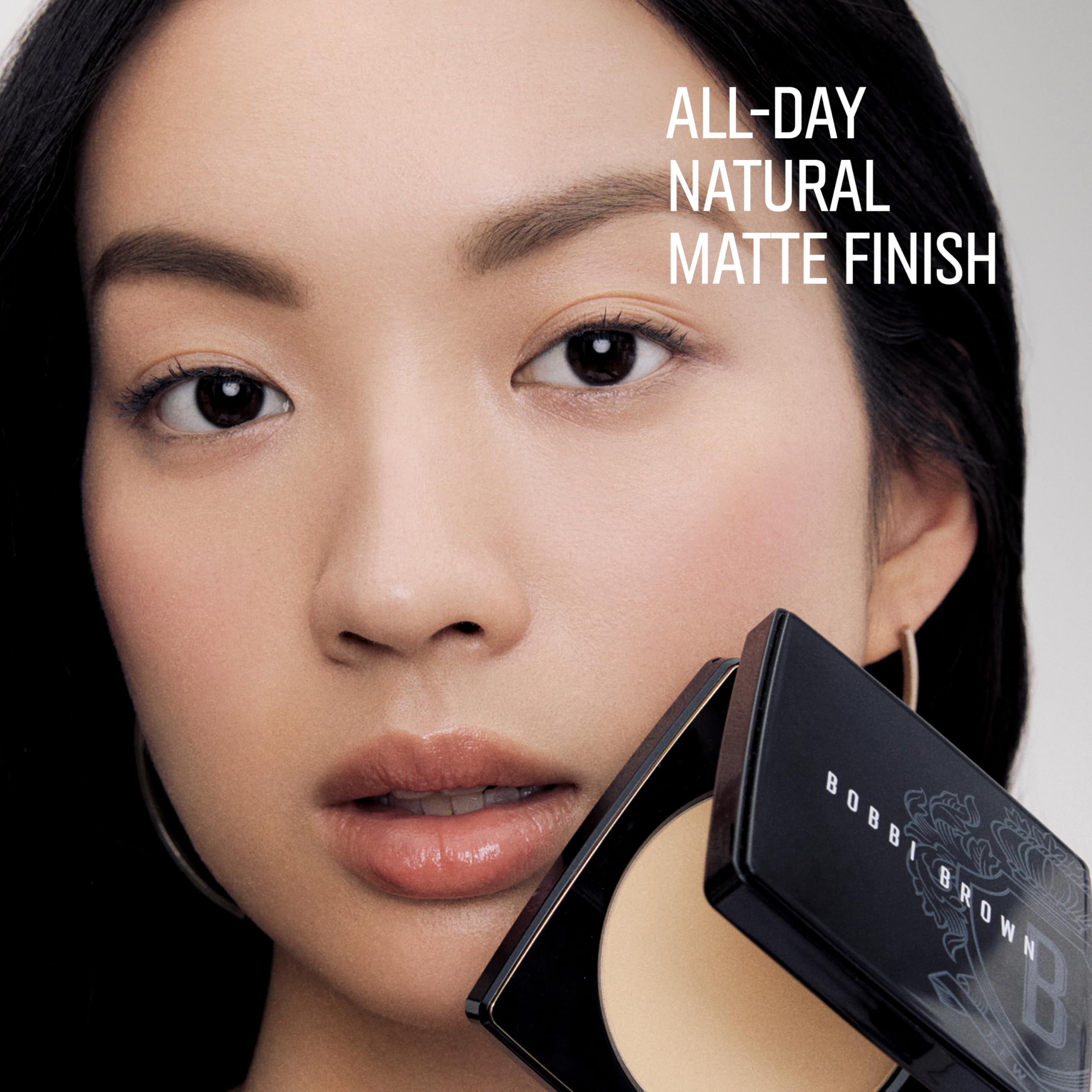 Bobbi Brown compact held in hand demonstrating travel-friendly 0.32 ounce size