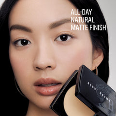 Bobbi Brown compact held in hand demonstrating travel-friendly 0.32 ounce size