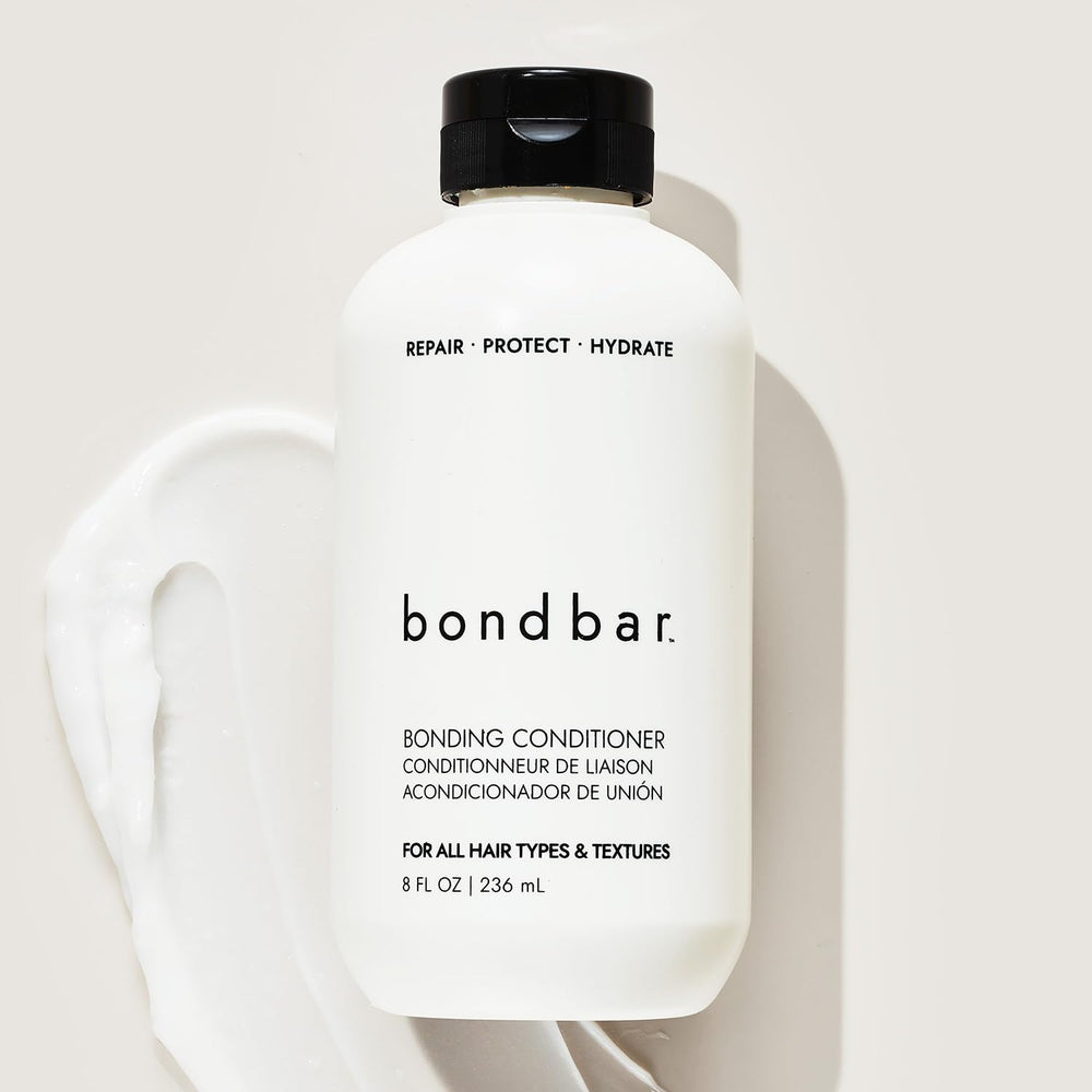 Applying Bondbar through wet hair illustrating improved detangling and manageability
