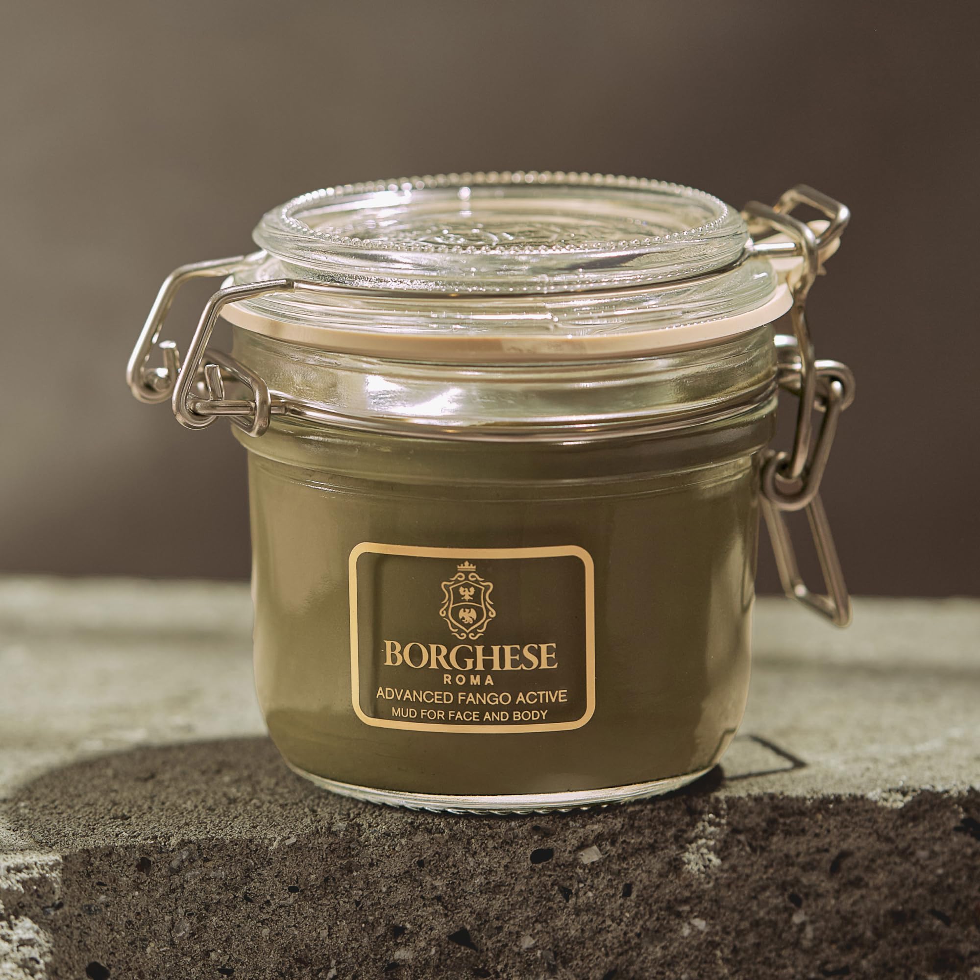 Hand holding Borghese 7.5 oz jar to show size and portability