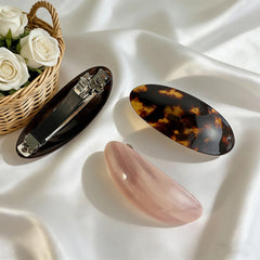 BOUNIQ barrette held in hand to show scale and comfortable size