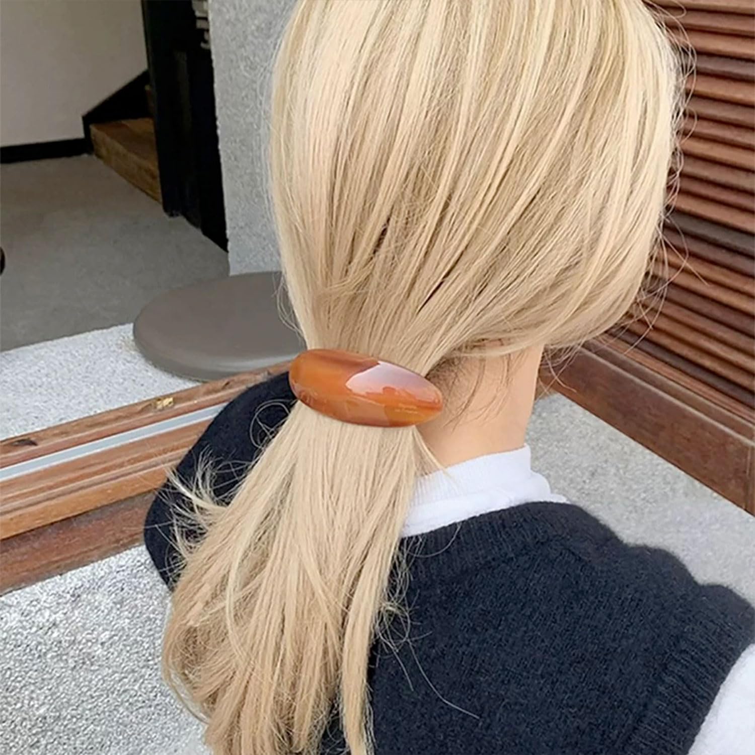 BOUNIQ half-up hairstyle secured with barrette for polished look