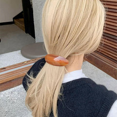 BOUNIQ half-up hairstyle secured with barrette for polished look