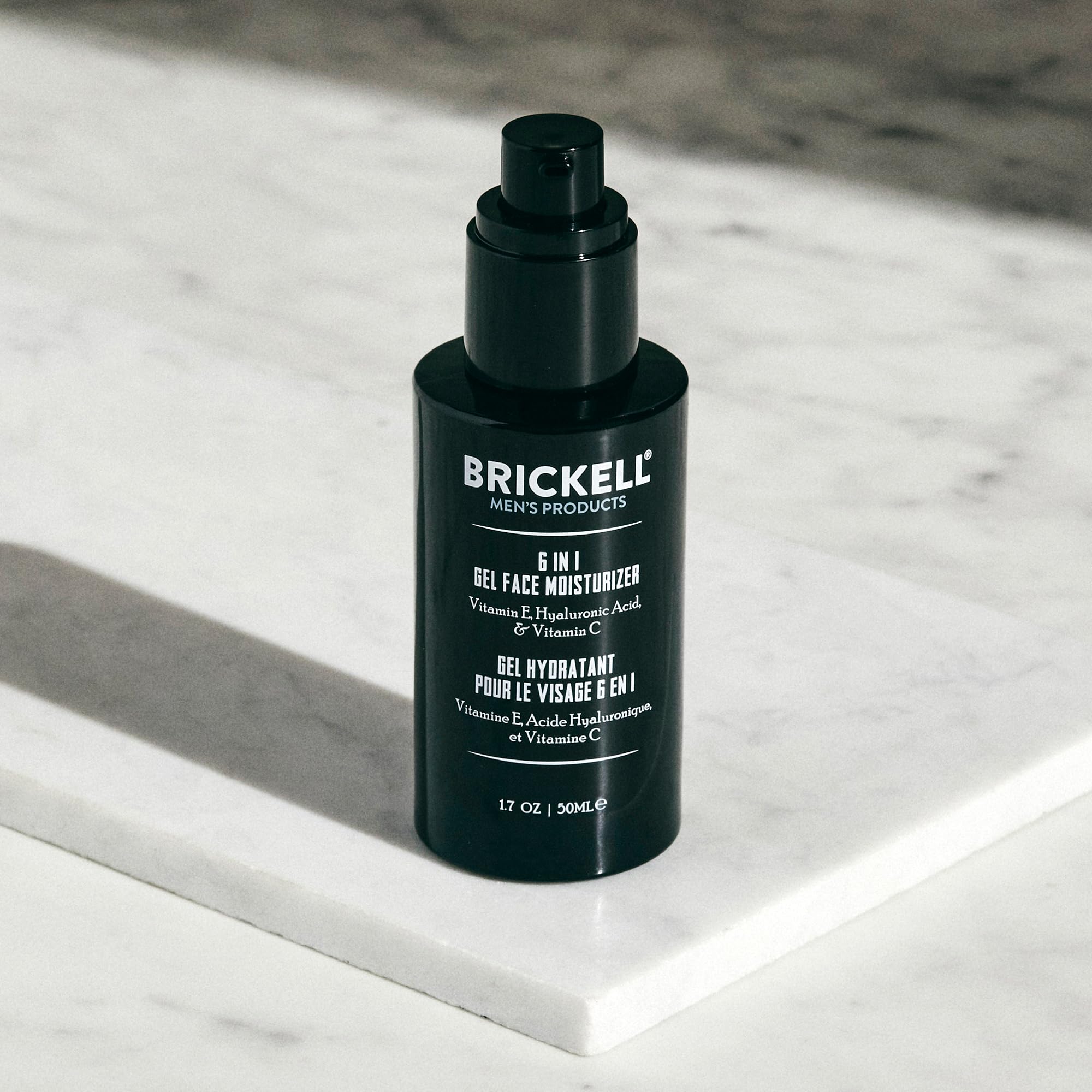 Brickell Men's Products next to common travel items showing 1.7 oz scale