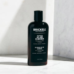 Brickell men's gel moisturizer held in hand to show 4oz scale and easy daily-usage benefit