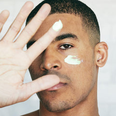 Brickell Men's Products cream on hand showing lightweight spreadability and quick absorption