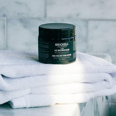 Brickell Men's Products jar on bedside table illustrating nightly skincare integration