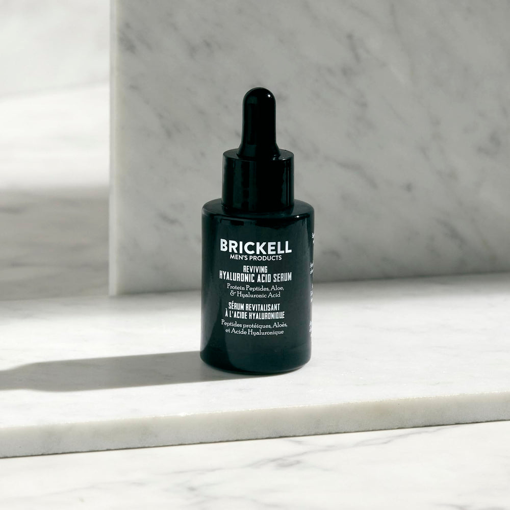 Brickell serum droplet on fingers demonstrating lightweight texture and instant hydration