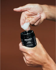Brickell scrub next to a coin showing 2 oz size for packing and portability