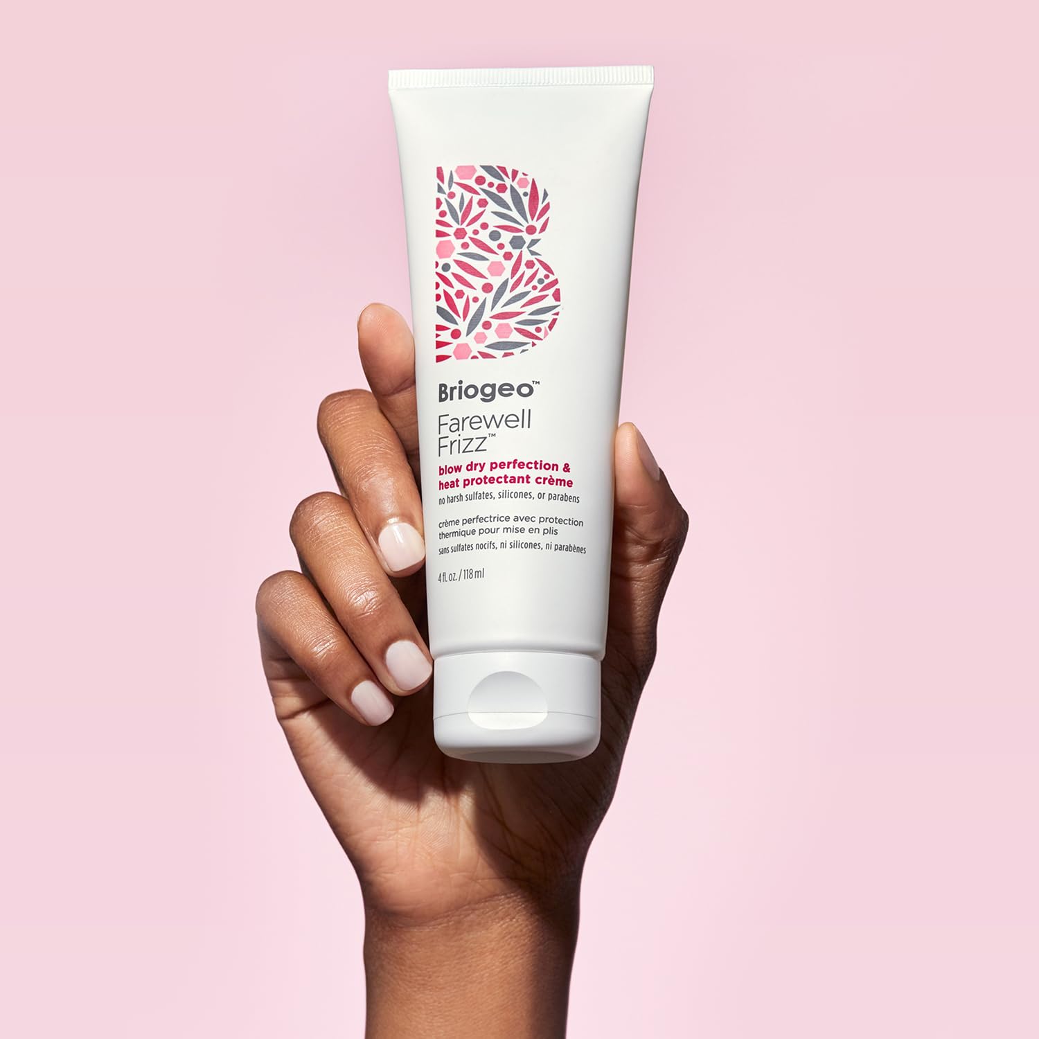 Briogeo 2 oz tube held in hand for scale, emphasizing travel-friendly convenience