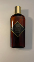 Brown Sugar Babe bottle next to hand showing scale and travel-friendly size benefit