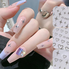 BSBTBZ sticker being applied with tweezers showing precise placement for neat nails