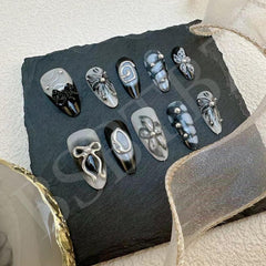 BSBTBZ nails worn on hands showing almond shape and dark design benefits