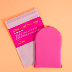 B.TAN mitt on bathroom vanity in lifestyle scene for at-home tanning ease