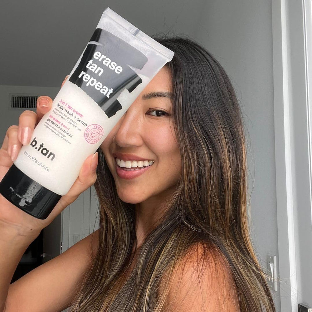 B.TAN bottle next to hand for size comparison showing compact travel benefit