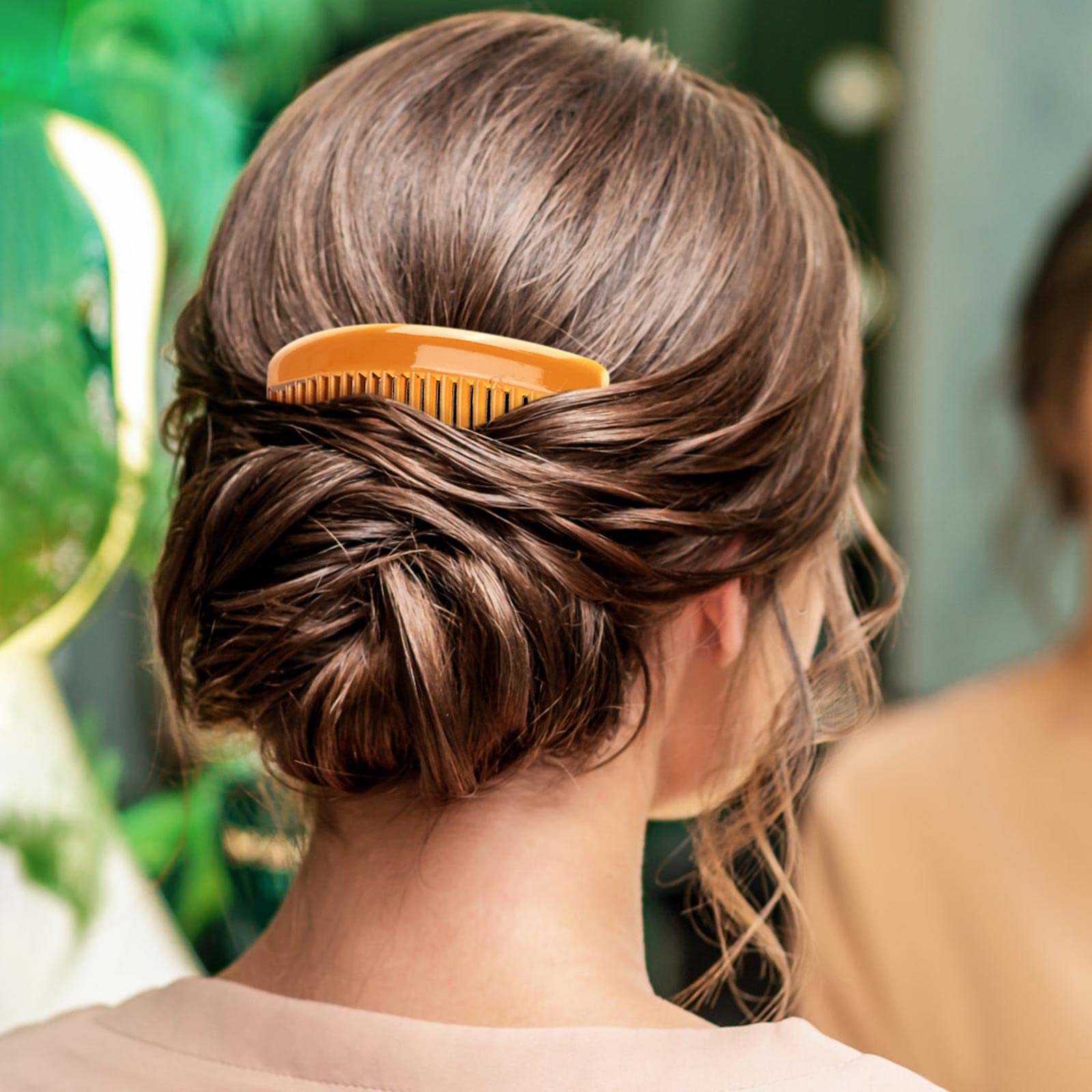 BTYMS comb held in hand showing size and lightweight convenience