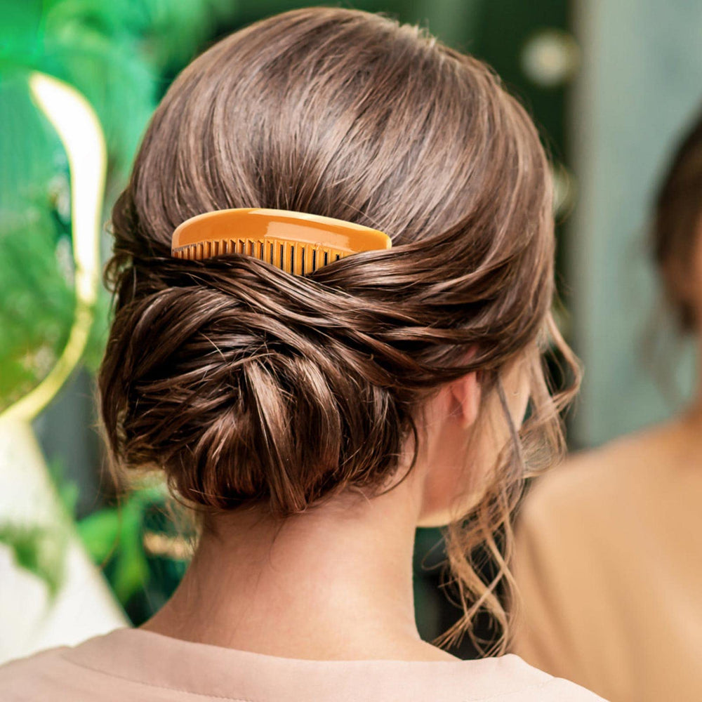 BTYMS comb held in hand showing size and lightweight convenience
