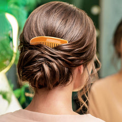 BTYMS comb held in hand showing size and lightweight convenience