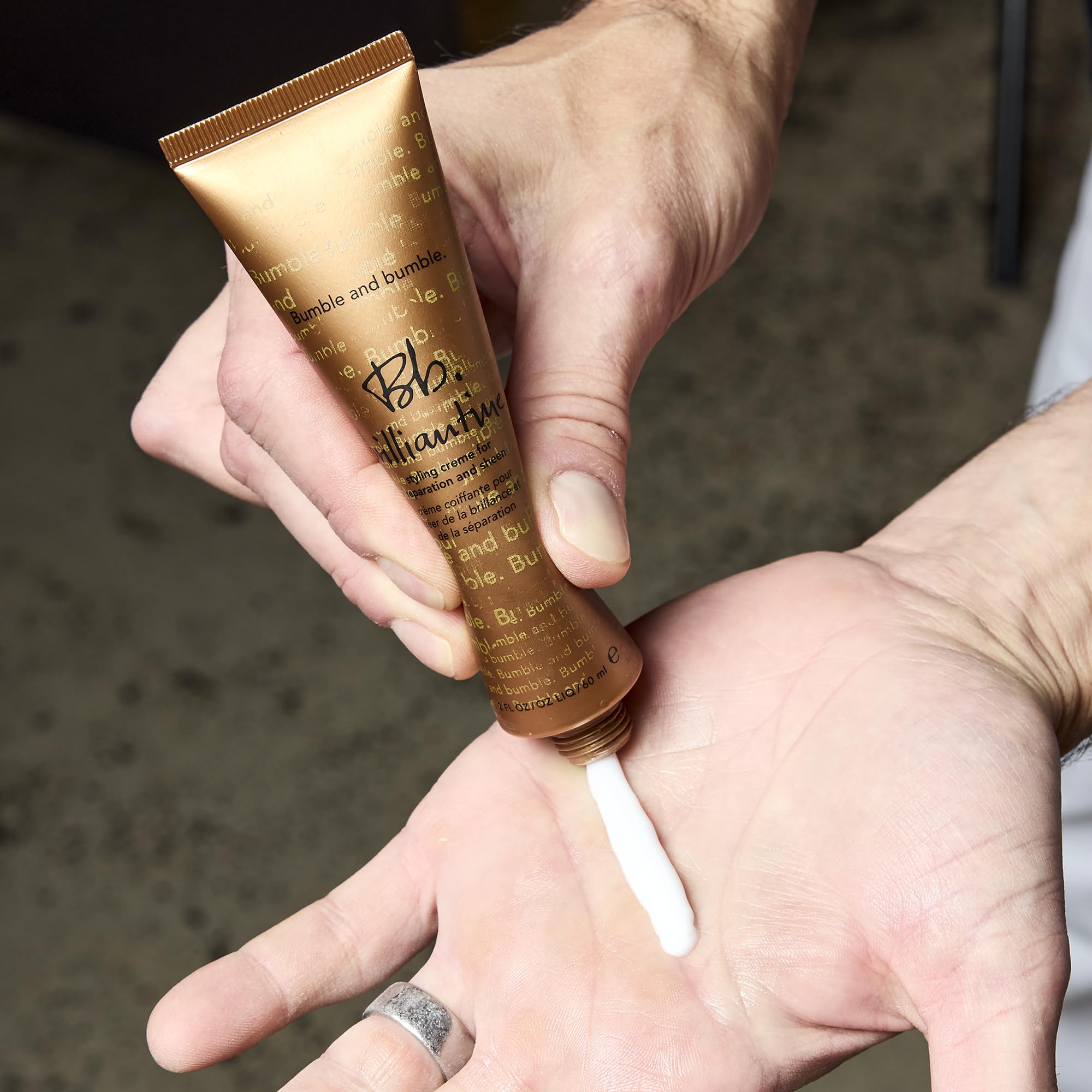 Bumble and bumble applying cream in hand for controlled styling