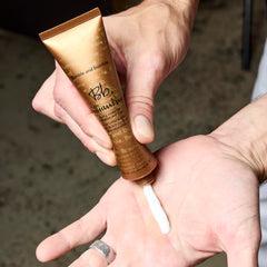 Bumble and bumble applying cream in hand for controlled styling