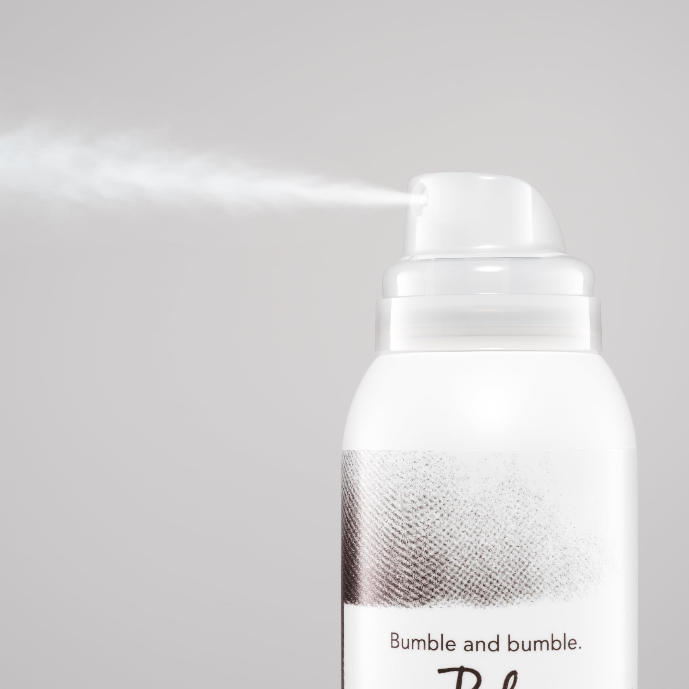Bumble and bumble application at roots on a model showing oil absorption and instant refresh