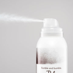 Bumble and bumble application at roots on a model showing oil absorption and instant refresh