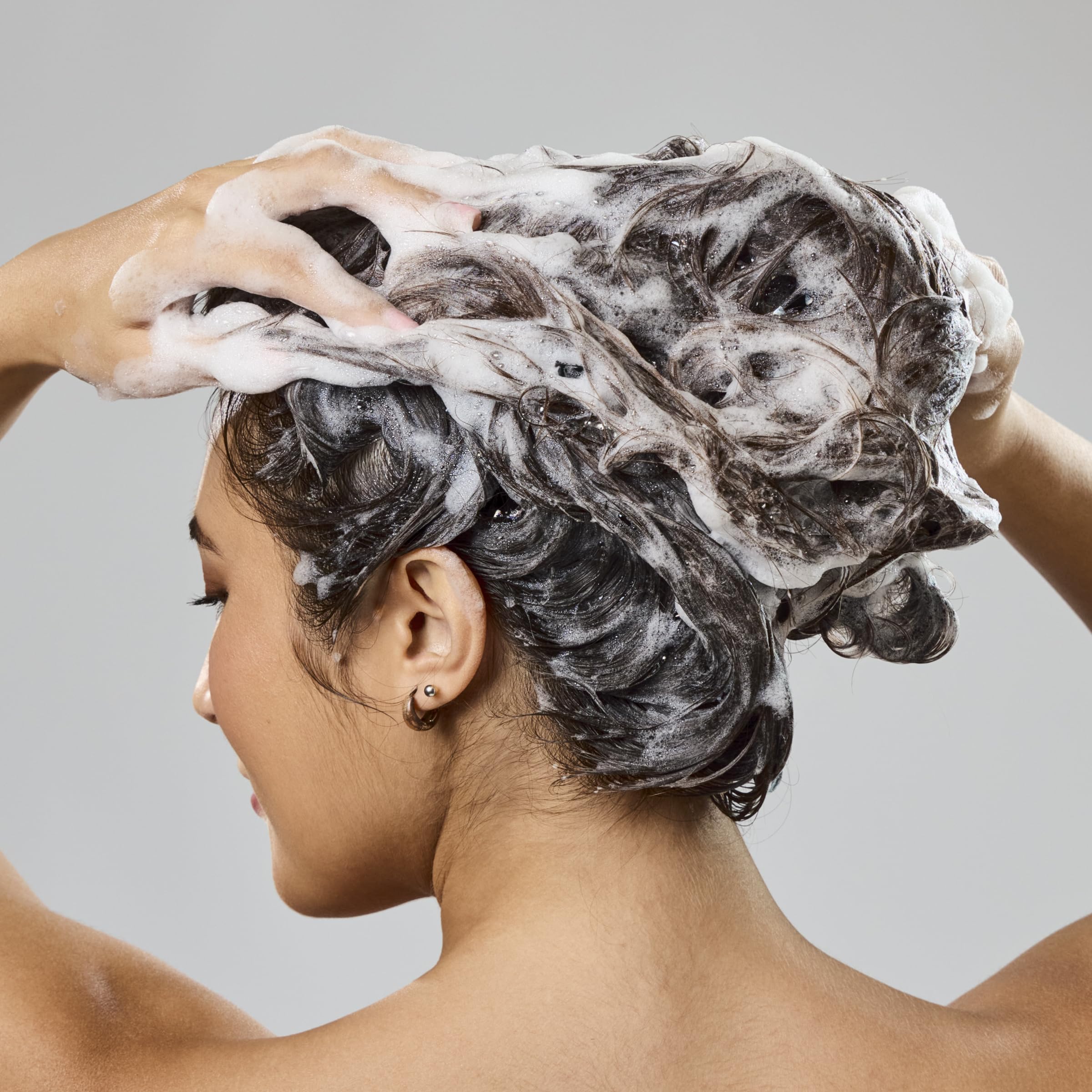 Bumble and bumble creamy shampoo texture closeup showing moisturizing lather