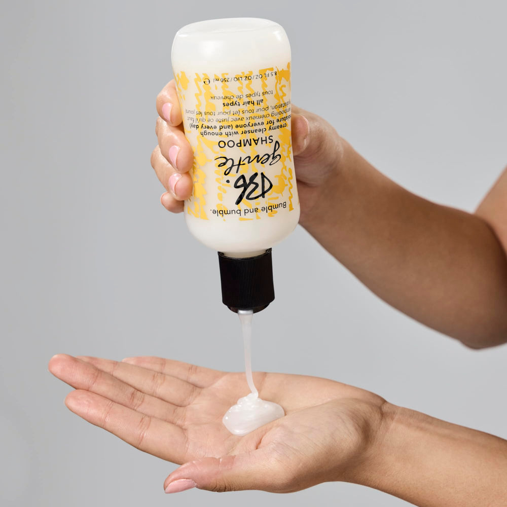 Bumble and bumble bottle in hand for size and travel-friendly scale