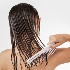 Bumble and bumble conditioner in shower applied to hair for detangling benefit