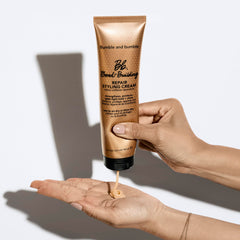 Bumble and bumble tube next to hand illustrating compact 5 fl oz travel-friendly size