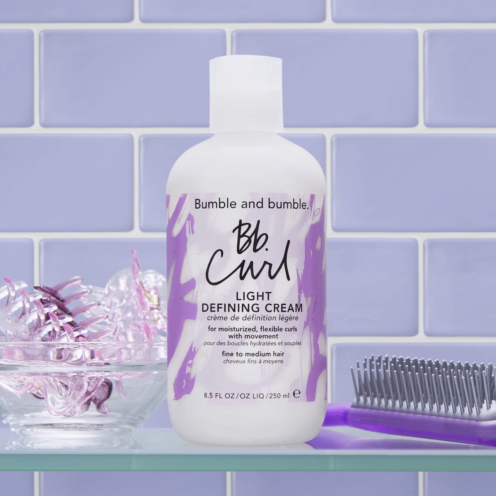 bumble and bumble size and scale next to hand showing 8.5 fl oz standard size for value