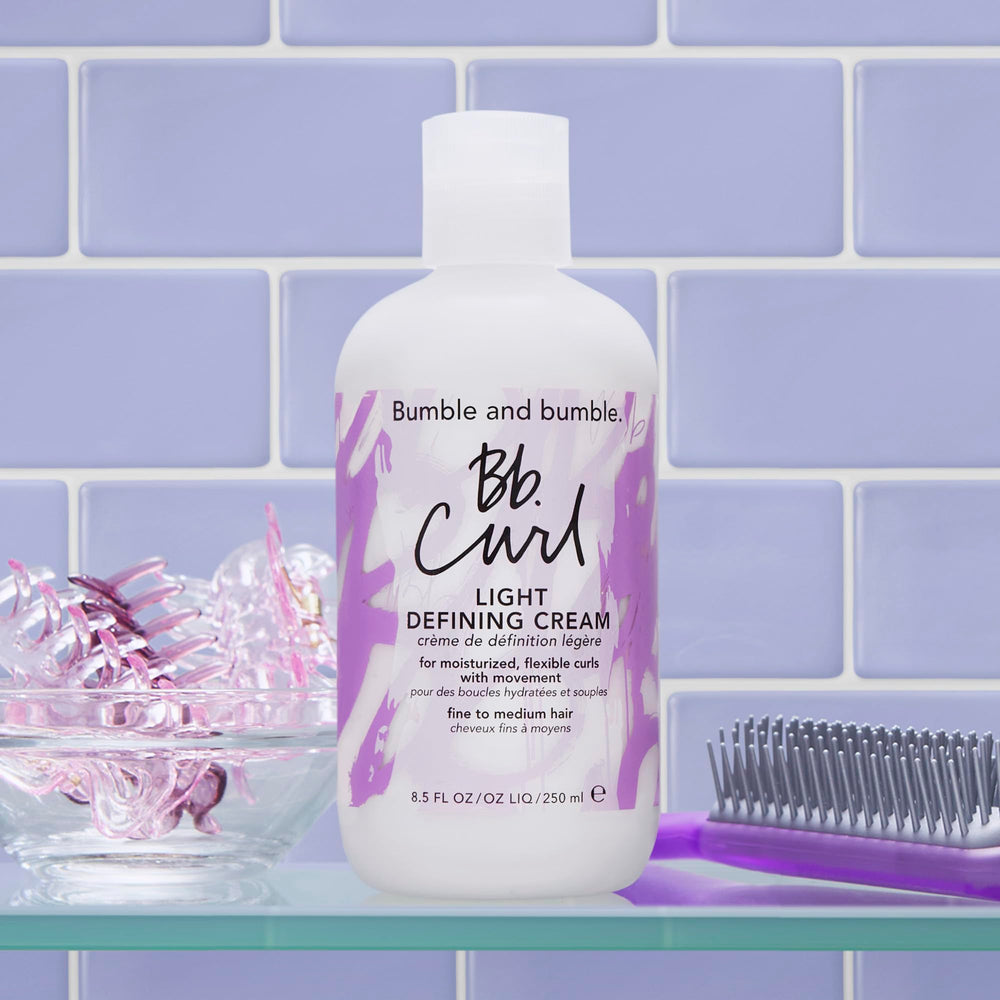 bumble and bumble size and scale next to hand showing 8.5 fl oz standard size for value