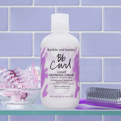 bumble and bumble size and scale next to hand showing 8.5 fl oz standard size for value