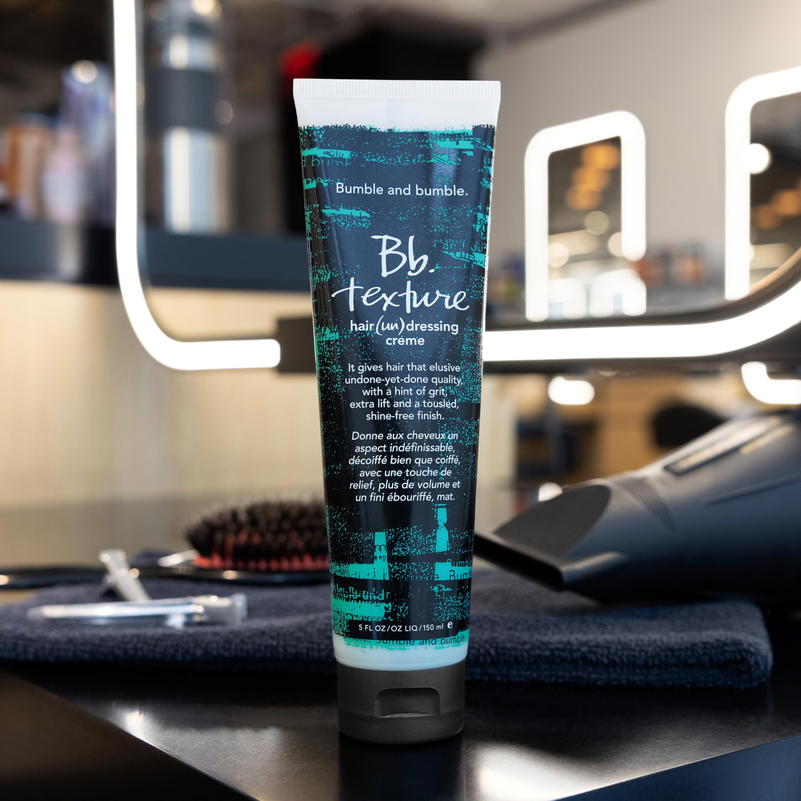 Bumble and bumble bottle staged with styled hair in lifestyle scene showing everyday use benefit