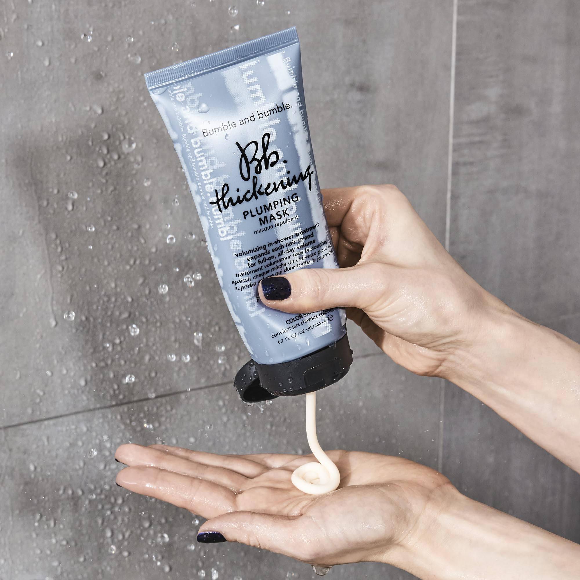 Bumble and bumble size comparison bottle next to hand for travel-friendly benefit